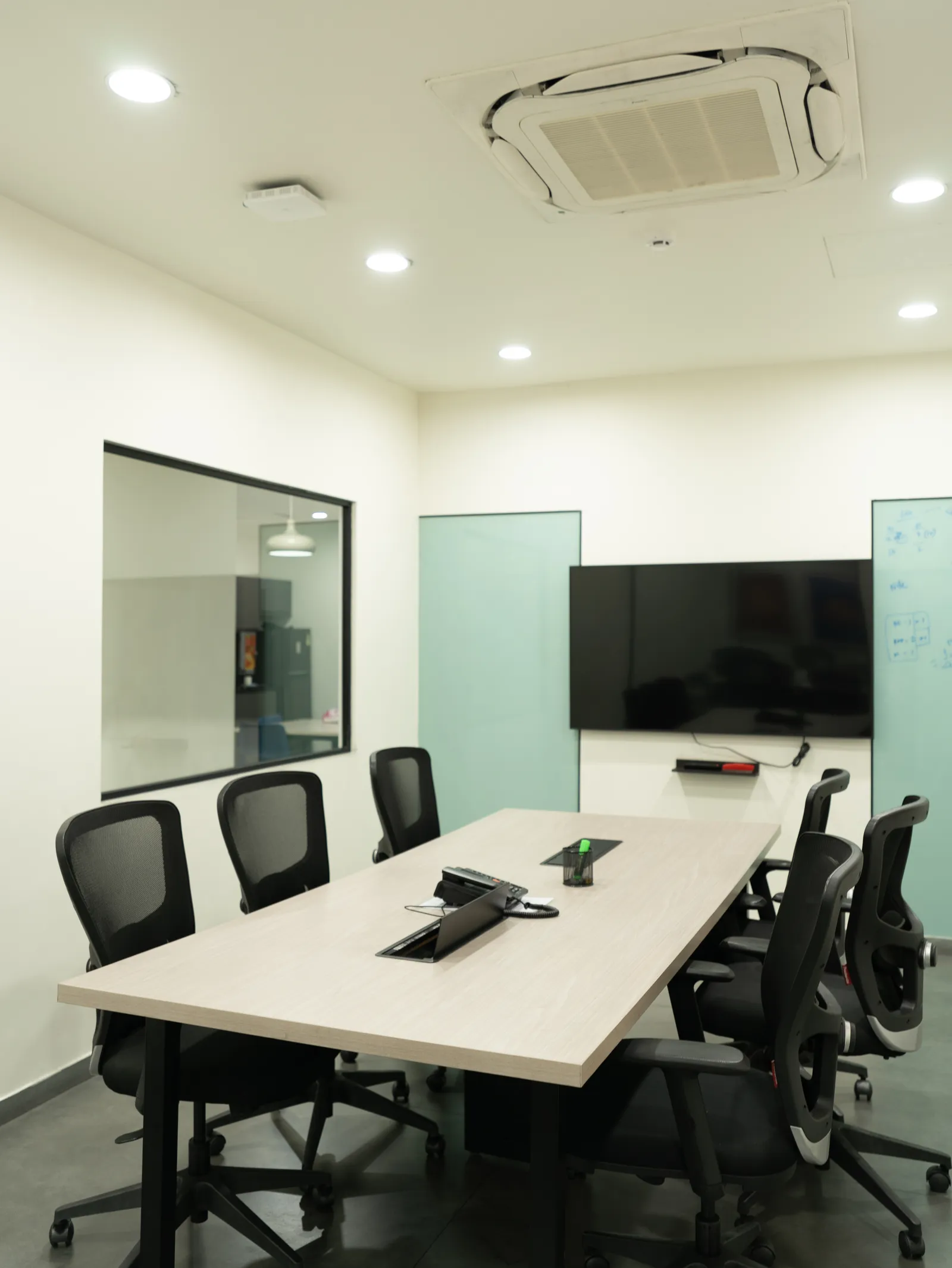 Meeting room with conference table and video screen — LICO